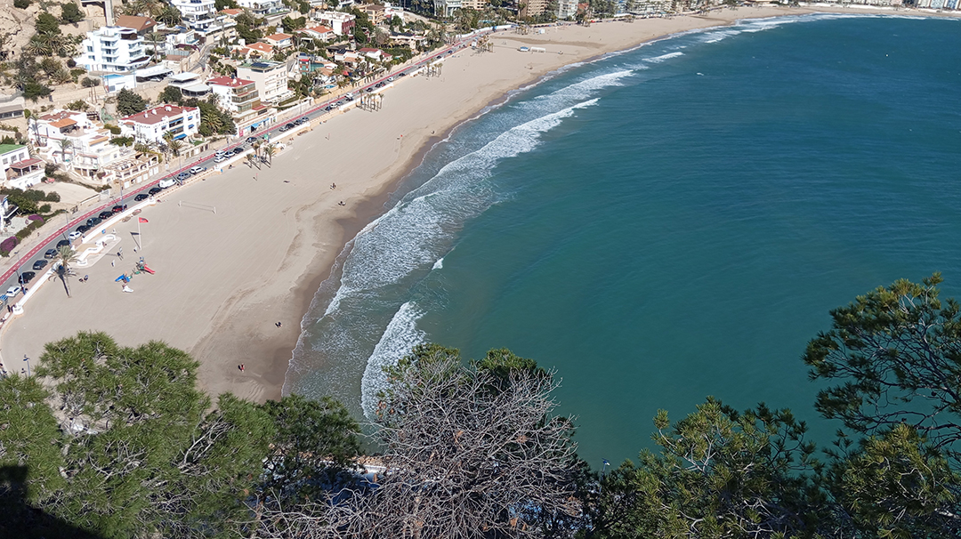 View of the sandy Costa Blanca coastline reveals the popular seaside destination of Alicante in southeastern Spain.