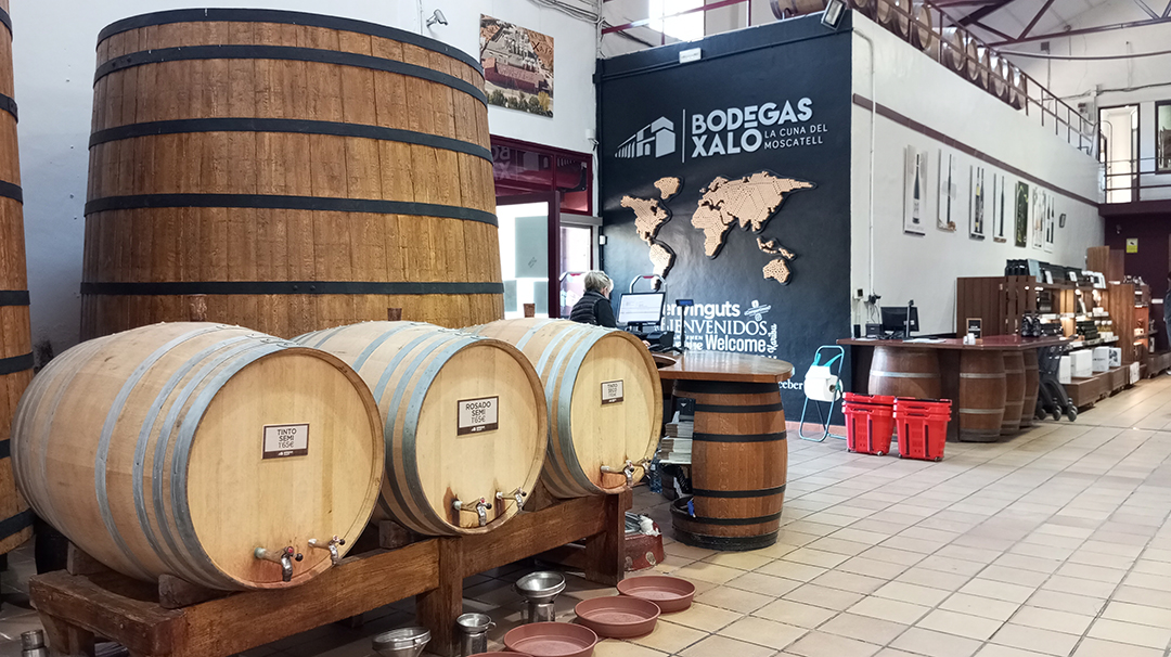Wooden wine barrels and the traditional interior of Claudio winery present Spanish wine heritage.