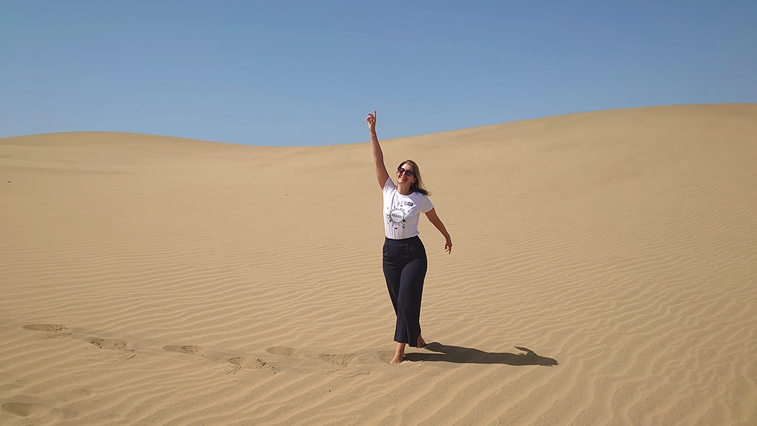 The Maspalomas dunes create a unique desert landscape by the ocean in southern Gran Canaria.