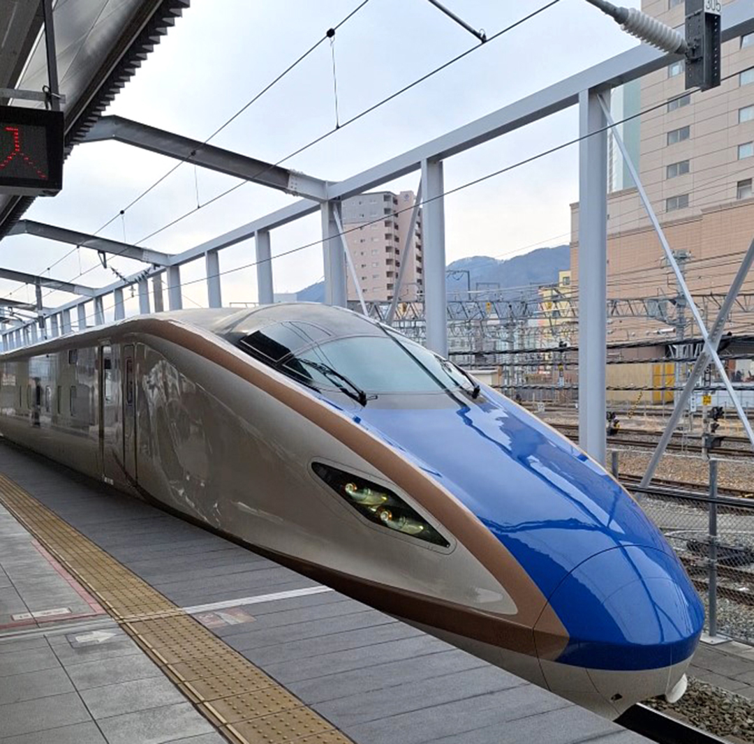 Blue Shinkansen bullet train at a railway station in Japan during a trip towards Nagano