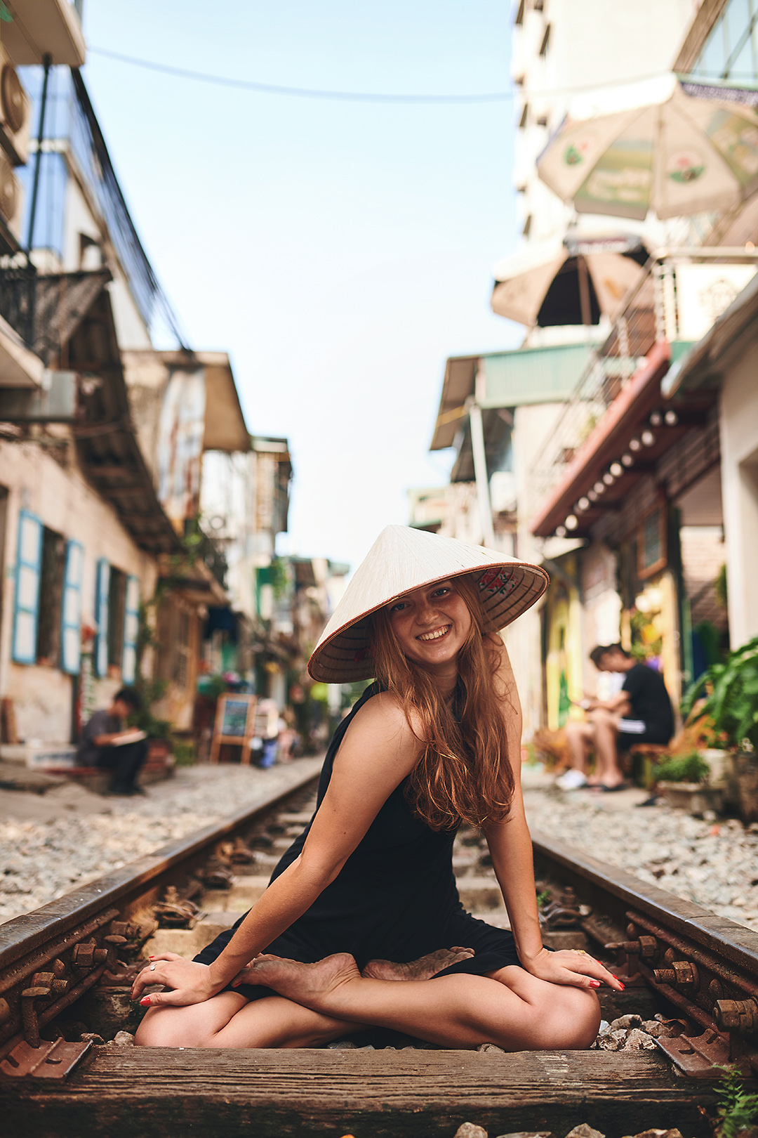 Traveller sitting on Hanoi's famous Train Street.