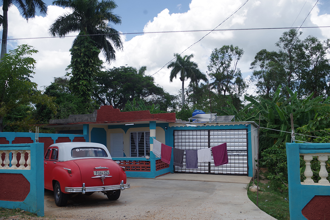 A traditional Cuban home and a classic vintage car reflect everyday life in Cuba, where history, tropical landscapes and local culture remain closely connected.
