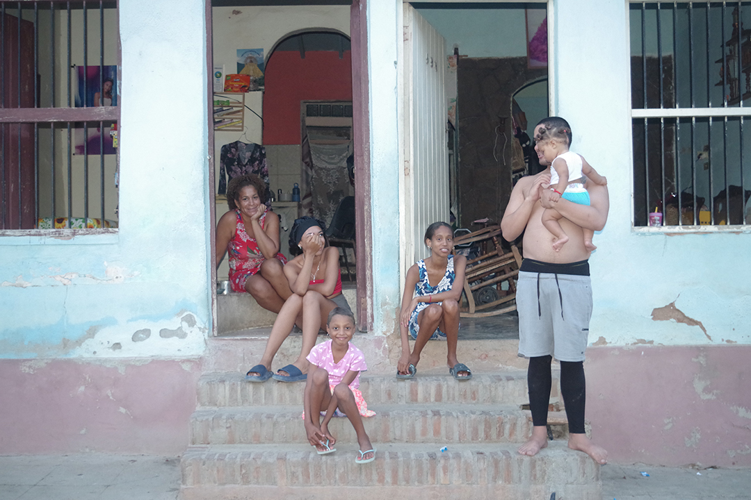 A Cuban family gathered outside their home reflects the warmth, hospitality and strong sense of community that characterise everyday life across the island.