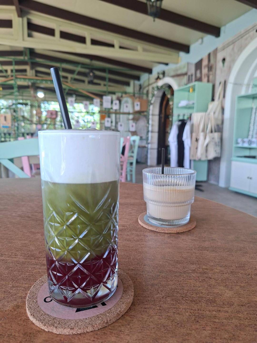 A matcha drink and coffee served at Cat Cafe Zepos Garden in Zakynthos, where every purchase helps support the care and adoption of rescued cats.